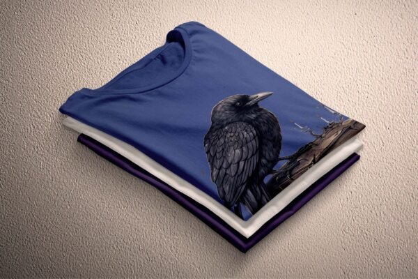 a black bird sitting on top of a blue shirt