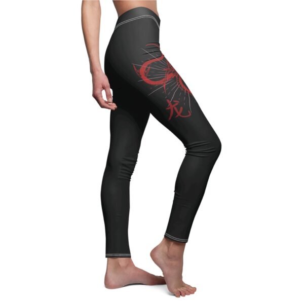 a woman wearing black and red leggings with a red dragon on the side