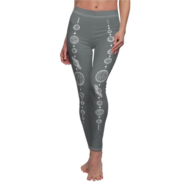 a woman in grey yoga pants with a pattern on the side