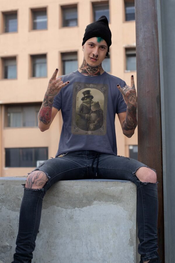 a man with tattoos sitting on a wall